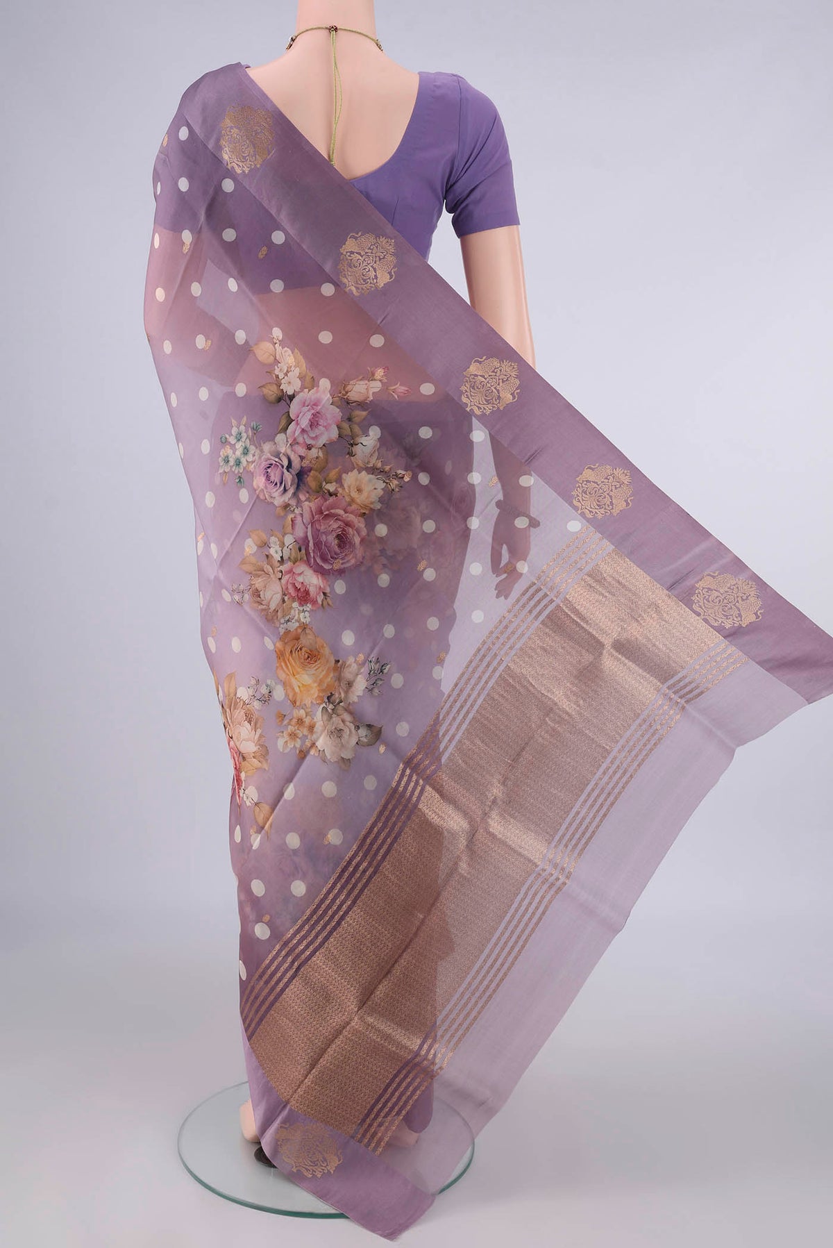 Flat view of Lilac Organza Saree with Zari Butta on the body and Satin Border. 