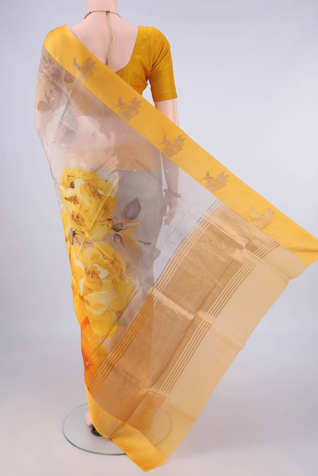 Flat view of Multi Color Organza Saree with Zari Butta on the body and Satin Border. 