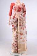 Beige Organza Saree with Floral Print on the body and Zari Border.  displayed on a mannequin