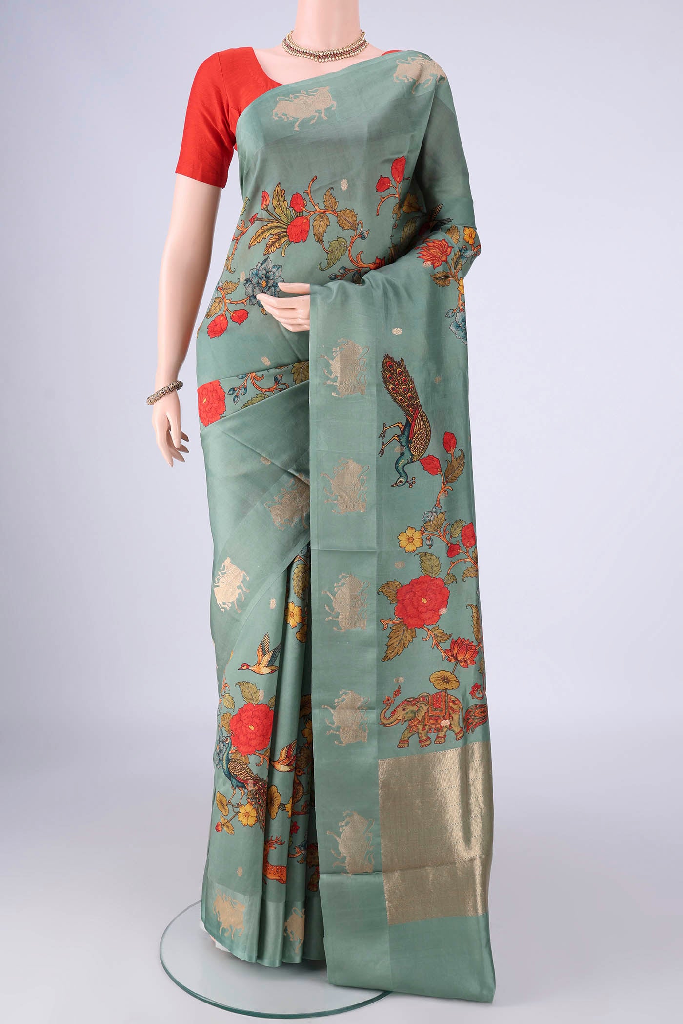 Sage Green Banarasi Katan Silk Saree with Floral Print on the body and Satin Border.  displayed on a mannequin