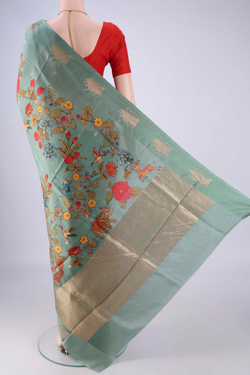 Flat view of Sage Green Banarasi Katan Silk Saree with Floral Print on the body and Satin Border. 
