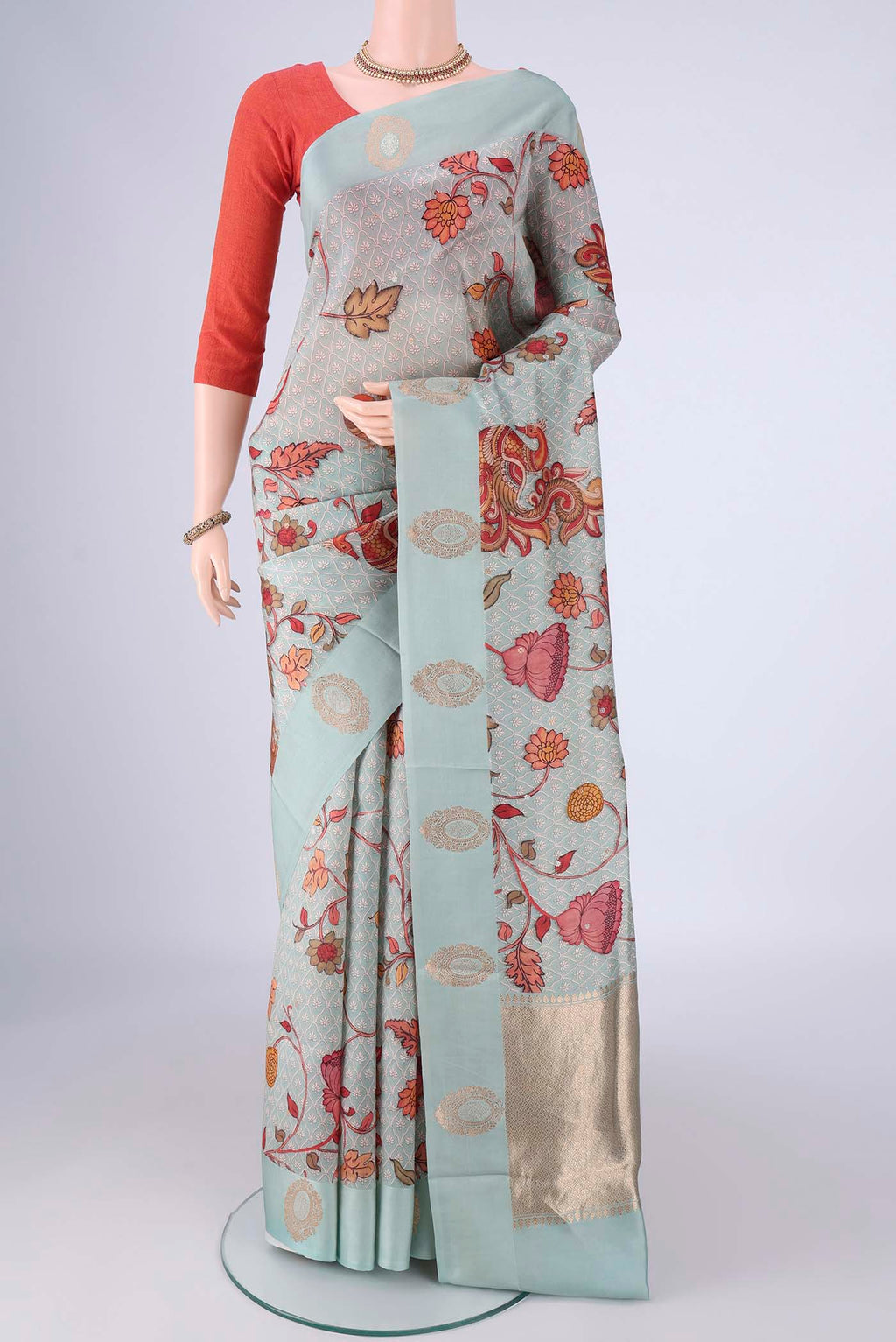 Sky Blue Banarasi Katan Silk Saree with Floral Print on the body and Satin Border.  displayed on a mannequin