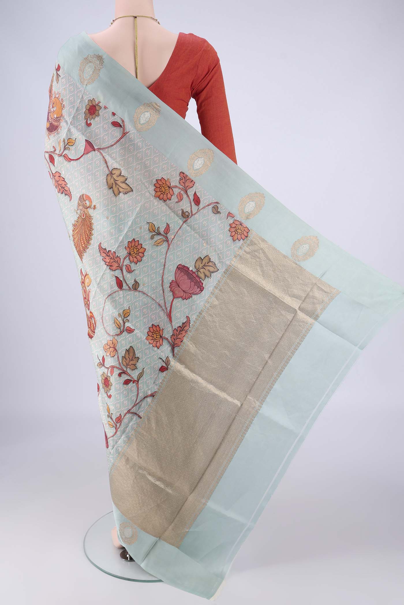 Flat view of Sky Blue Banarasi Katan Silk Saree with Floral Print on the body and Satin Border. 