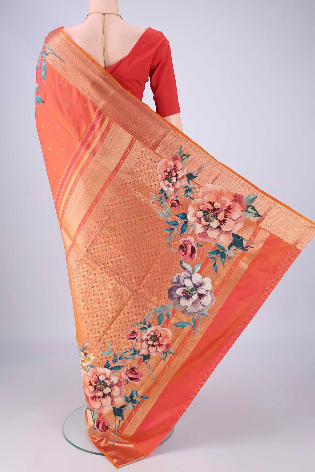 Flat view of Orange Kanjivaram Silk Saree with Zari Butta on the body and Zari Border. 