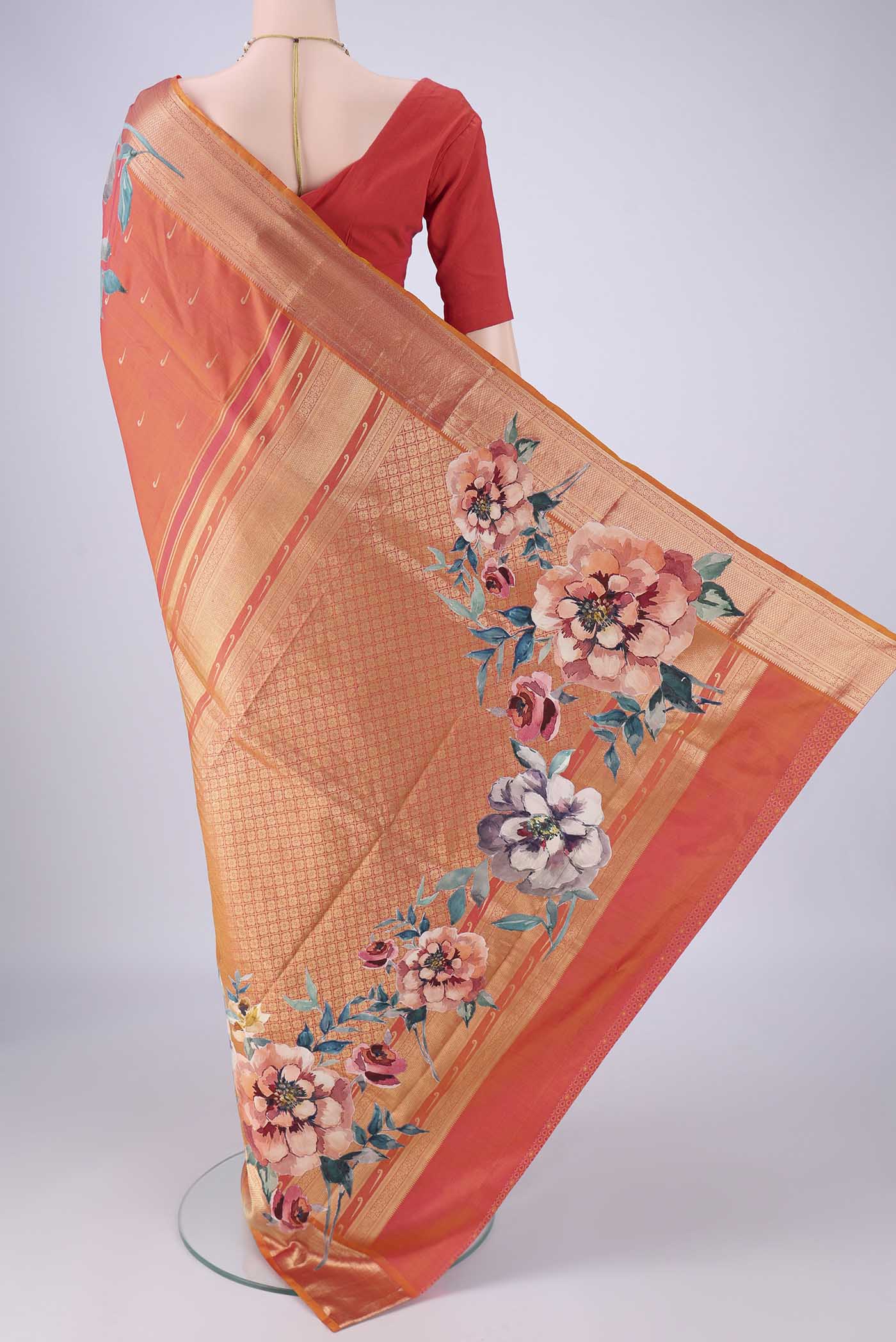 Flat view of Orange Kanjivaram Silk Saree with Zari Butta on the body and Zari Border. 