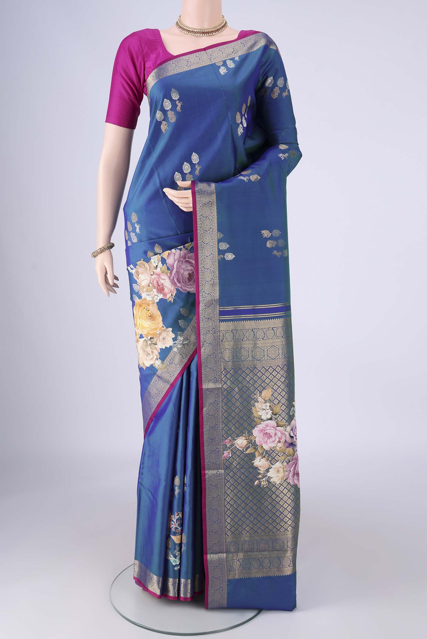 Blue Kanjivaram Silk Saree with Zari Butta on the body and Zari Border.  displayed on a mannequin