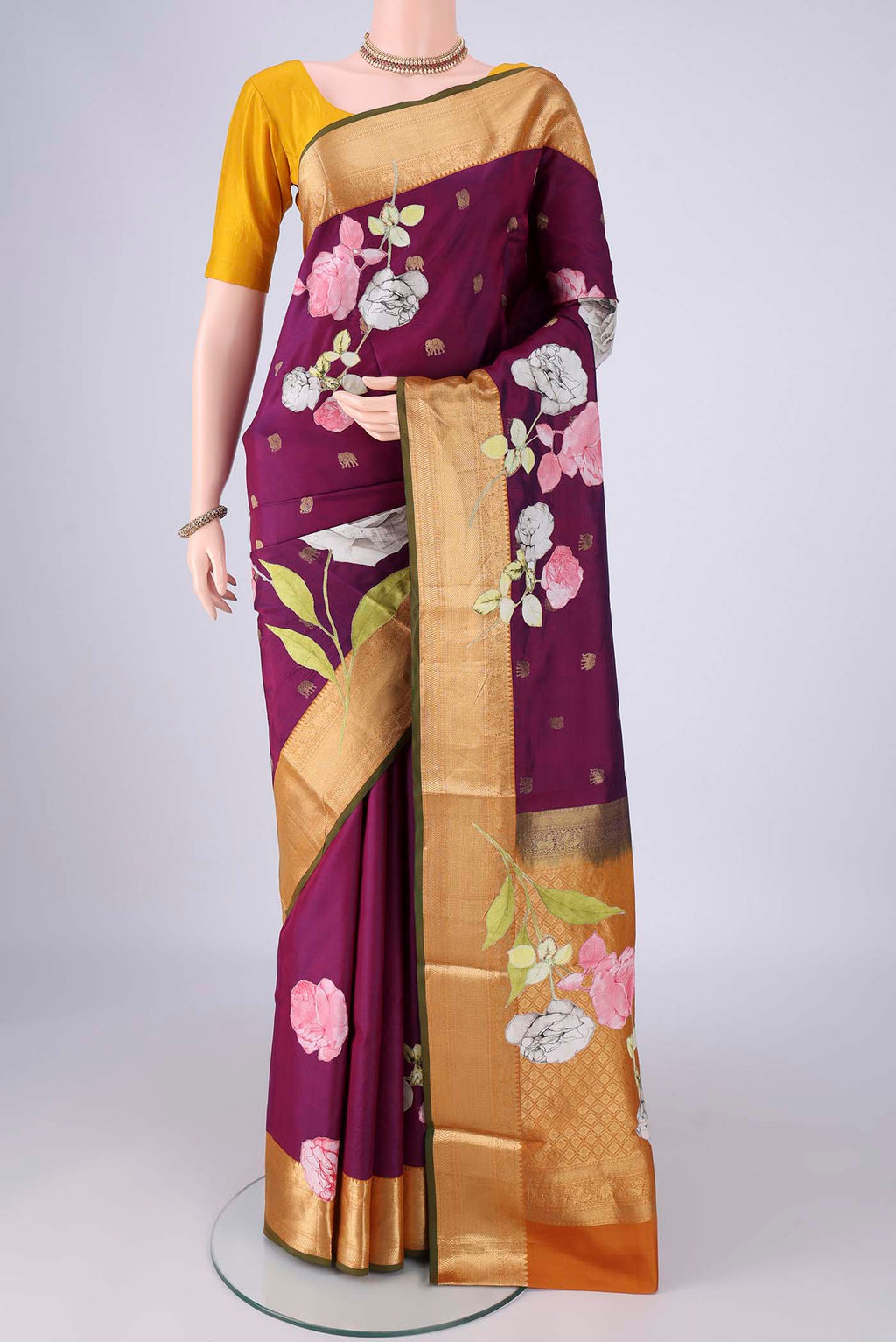 Purple Kanjivaram Silk Saree with Zari Butta on the body and Zari Border.  displayed on a mannequin