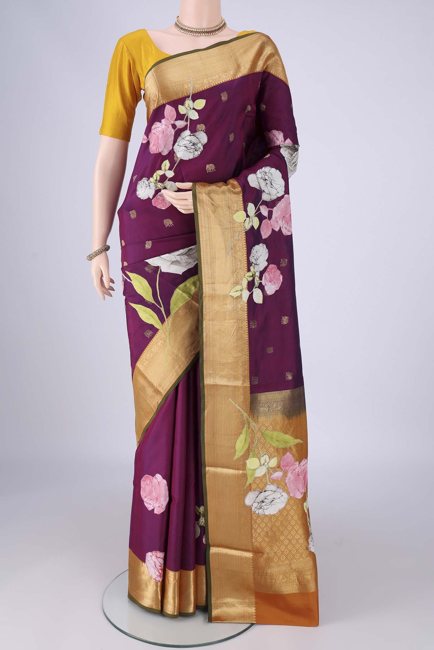 Purple Kanjivaram Silk Saree with Zari Butta on the body and Zari Border.  displayed on a mannequin
