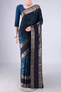 Navy Blue Kanchipuram Silk Saree with Floral Print on the body and Zari Border.  displayed on a mannequin