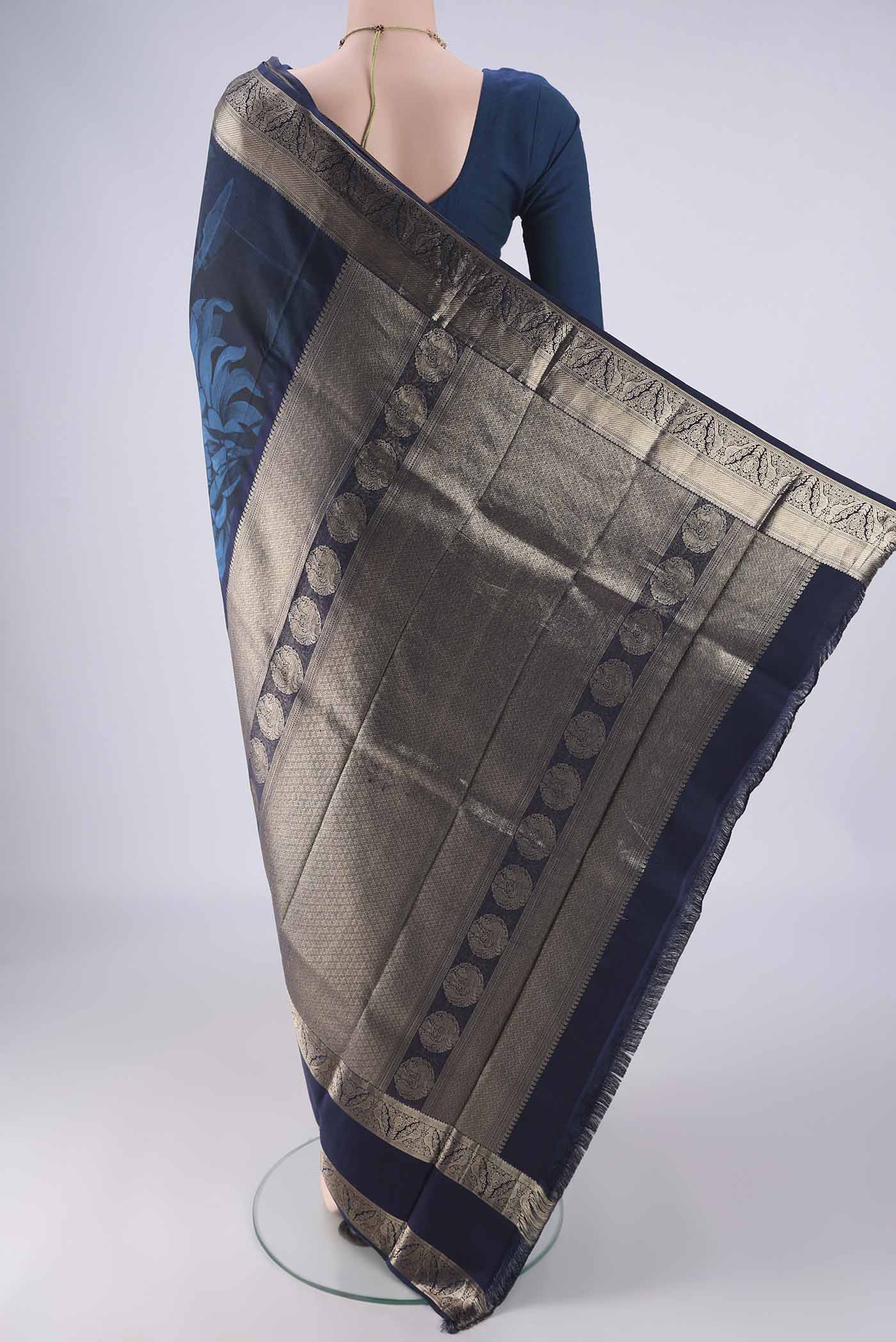 Flat view of Navy Blue Kanchipuram Silk Saree with Floral Print on the body and Zari Border. 