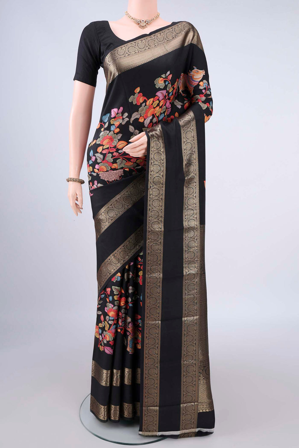 Pure Silk Black Printed Saree with Printed design on the body and Zari Border.  displayed on a mannequin