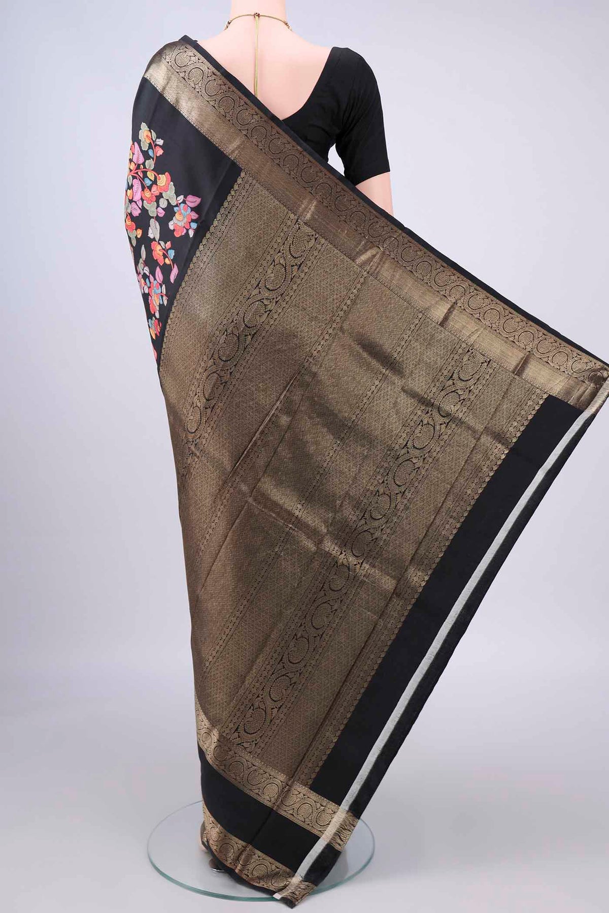 Flat view of Pure Silk Black Printed Saree with Printed design on the body and Zari Border. 