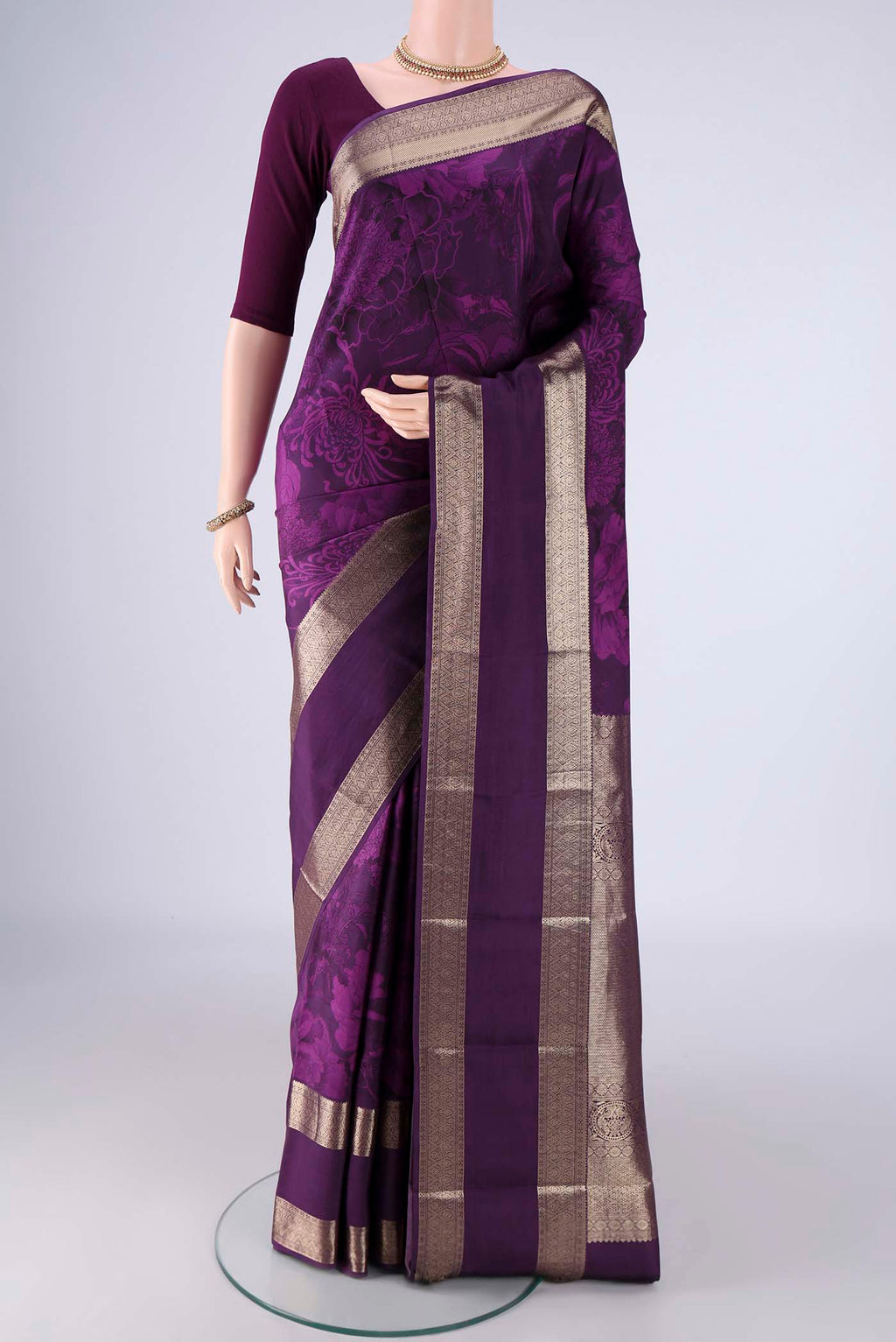 Purple Printed Silk Saree with Floral Print on the body and Zari Border.  displayed on a mannequin