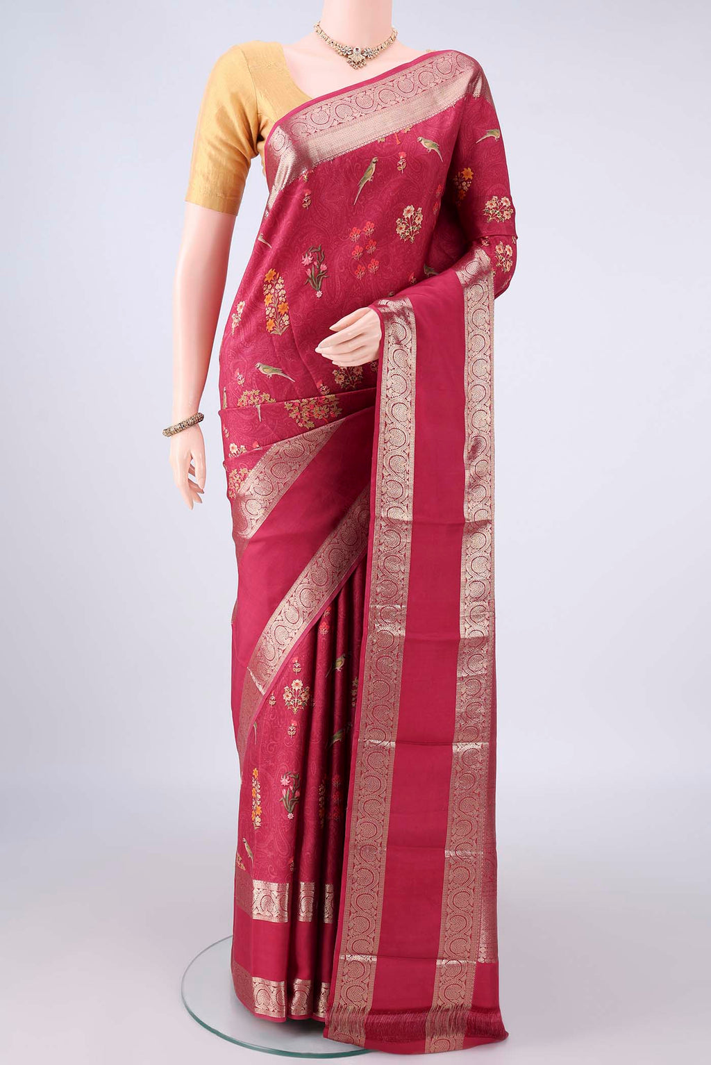Pure Silk Coral Printed Saree with Printed design on the body and Zari Border.  displayed on a mannequin