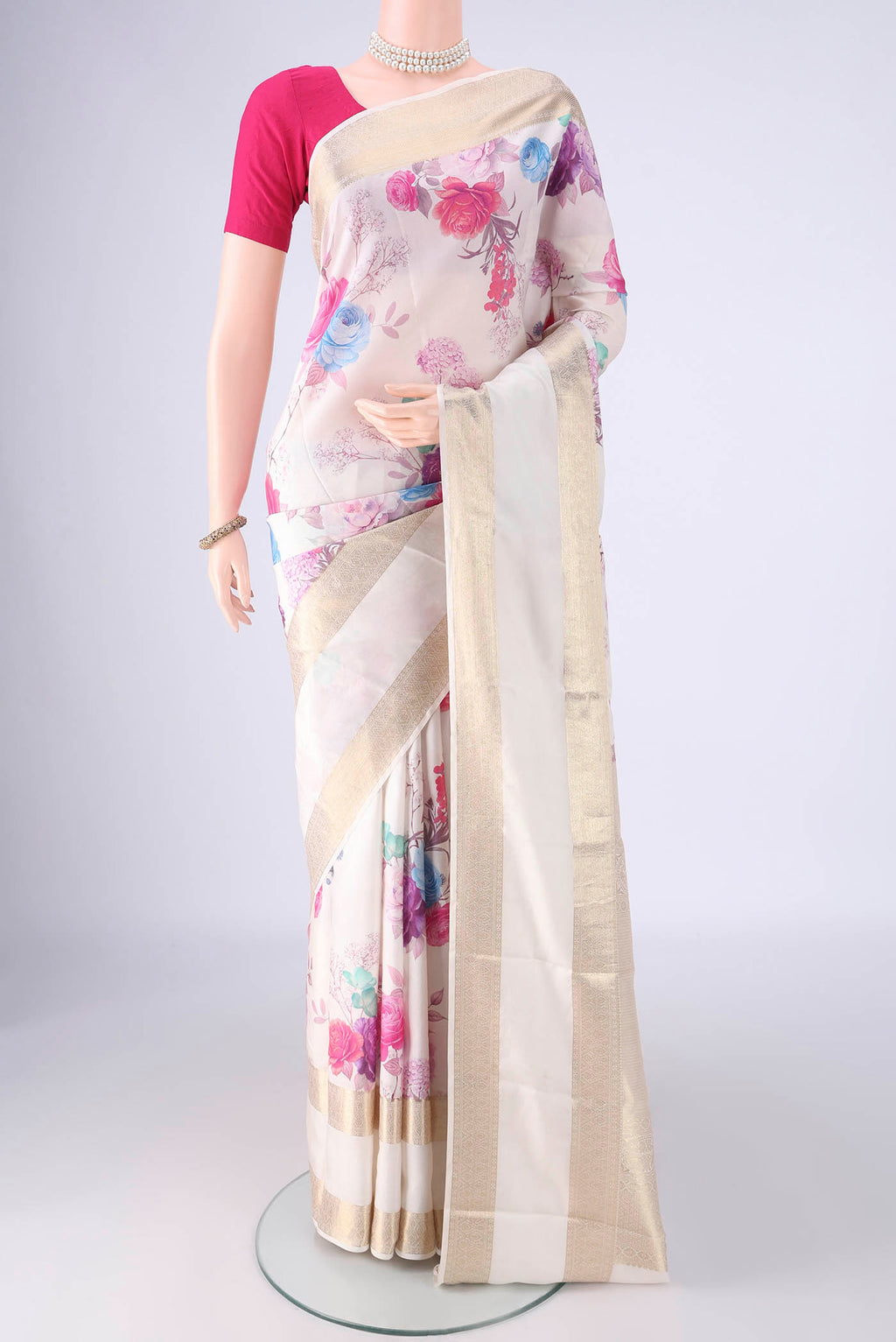 Off White Kanchipuram Silk Saree with Floral Print on the body and Zari Border.  displayed on a mannequin