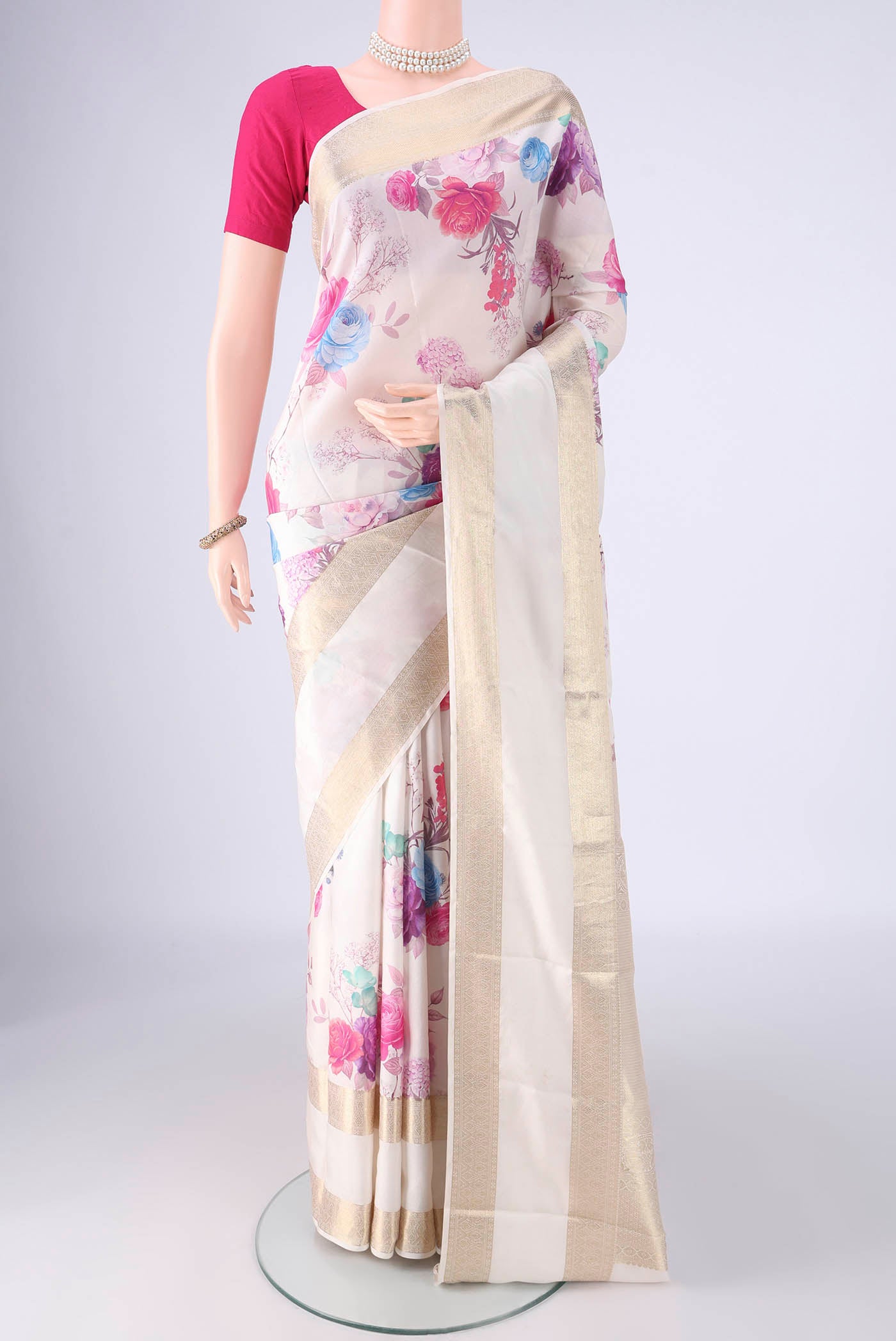 Off White Kanchipuram Silk Saree with Floral Print on the body and Zari Border.  displayed on a mannequin