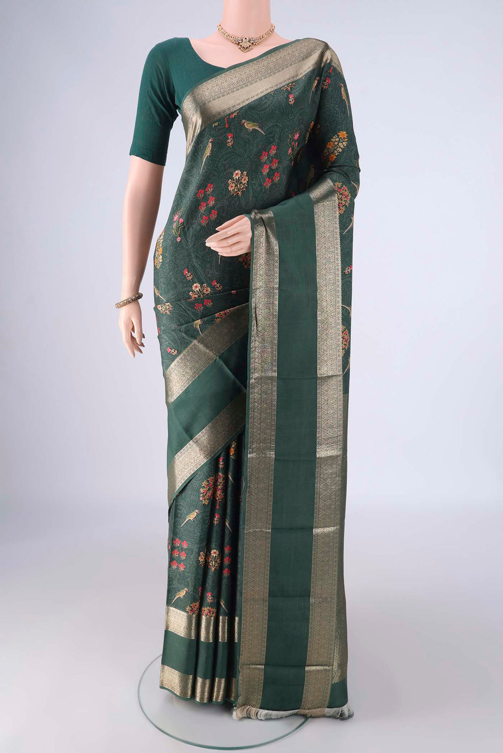 Olive Green Kanchipuram Silk Saree with Floral Print on the body and Zari Border.  displayed on a mannequin