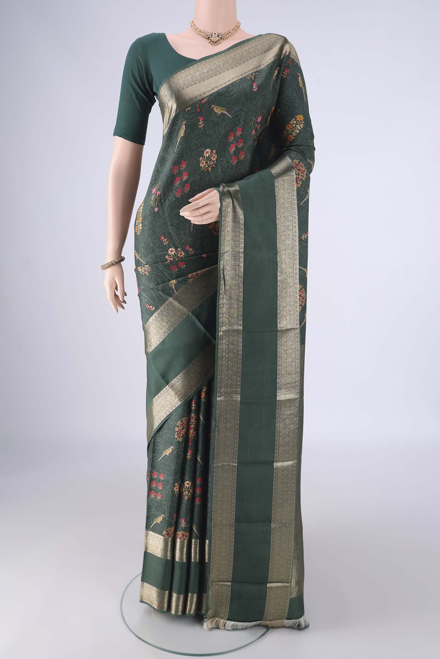 Olive Green Kanchipuram Silk Saree with Floral Print on the body and Zari Border.  displayed on a mannequin