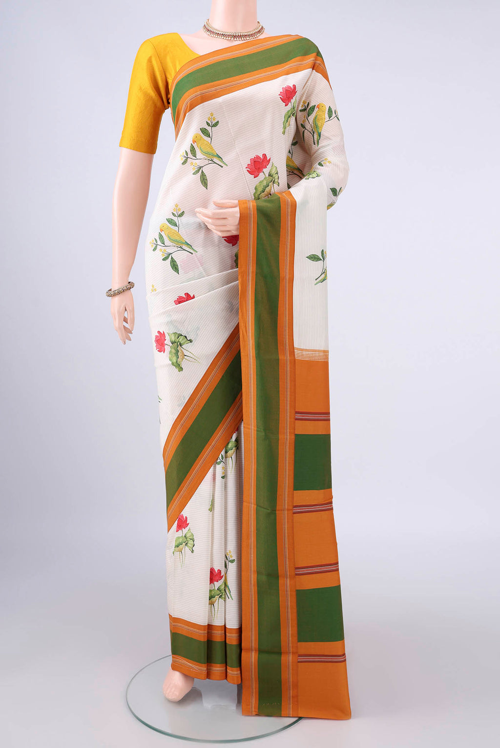 Pure Silk Cream Printed Saree with Printed design on the body and Thread Border.  displayed on a mannequin