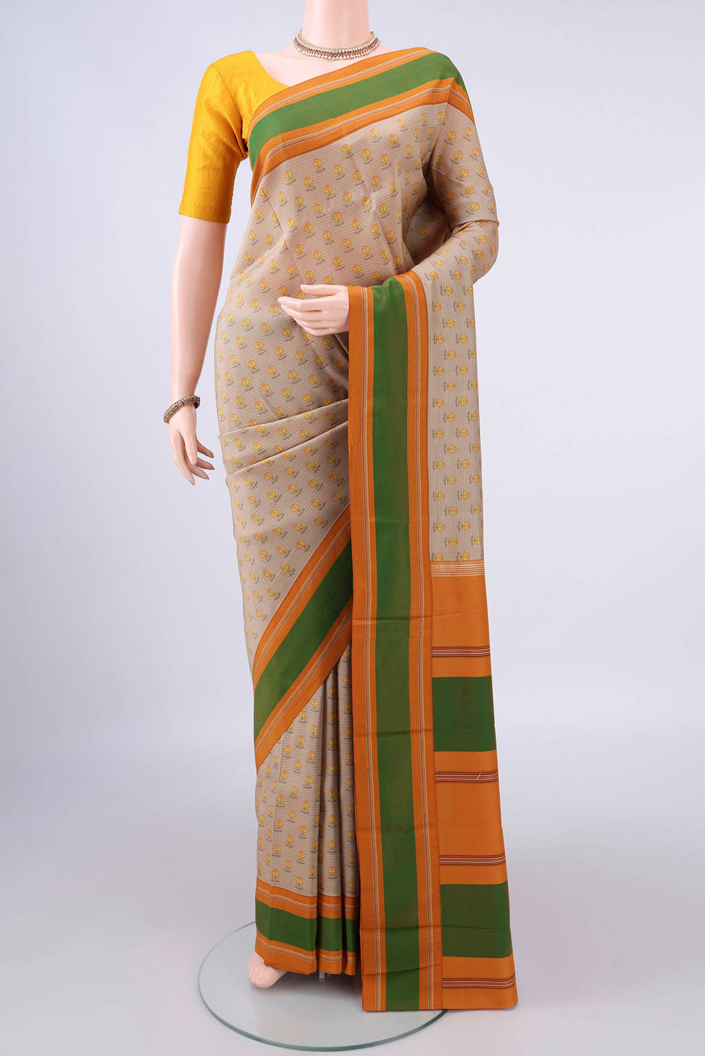 Pure Silk Beige Printed Saree with Printed design on the body and Thread Border.  displayed on a mannequin