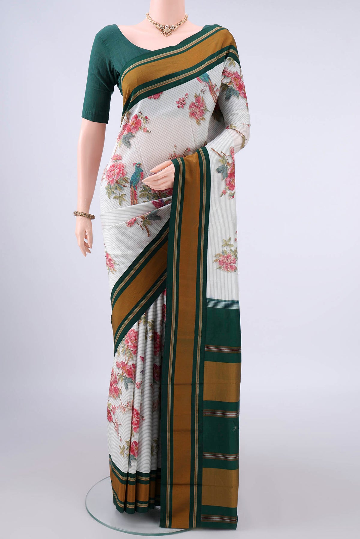Pure Silk White Printed Saree with Printed design on the body and Plain Border.  displayed on a mannequin