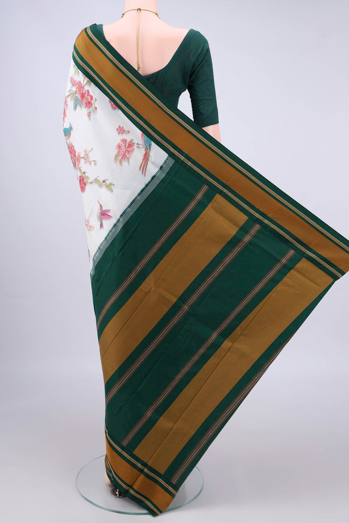 Flat view of Pure Silk White Printed Saree with Printed design on the body and Plain Border. 