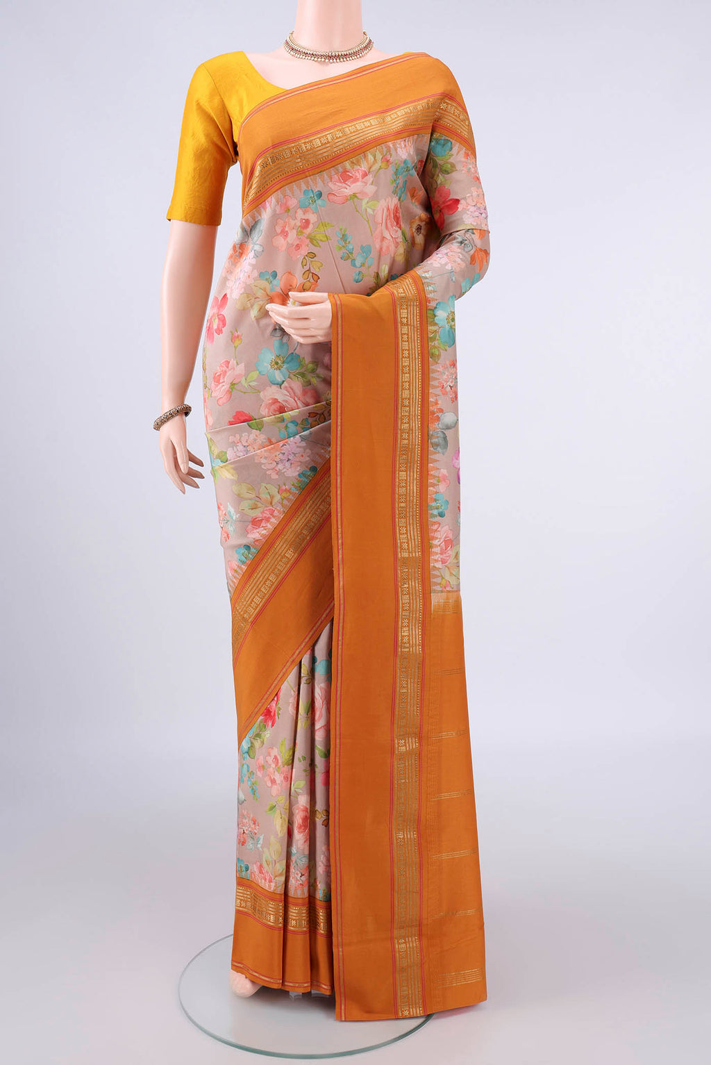 Pure Silk Beige Printed Saree with Floral Print on the body and Zari Border.  displayed on a mannequin