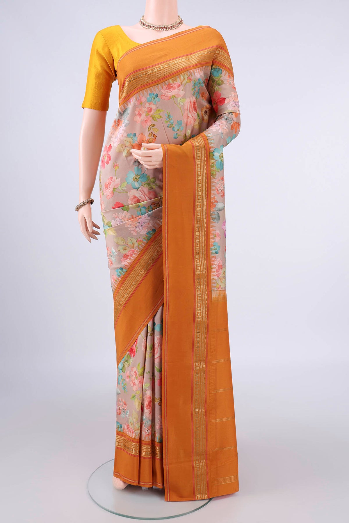 Pure Silk Beige Printed Saree with Floral Print on the body and Zari Border.  displayed on a mannequin