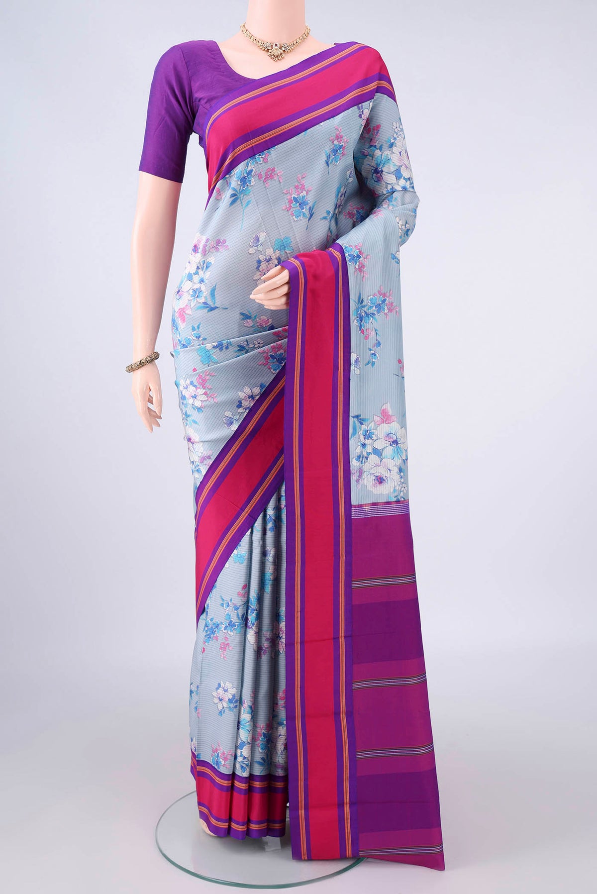 Pure Silk Sky Blue Printed Saree with Floral Print on the body and Plain Border.  displayed on a mannequin