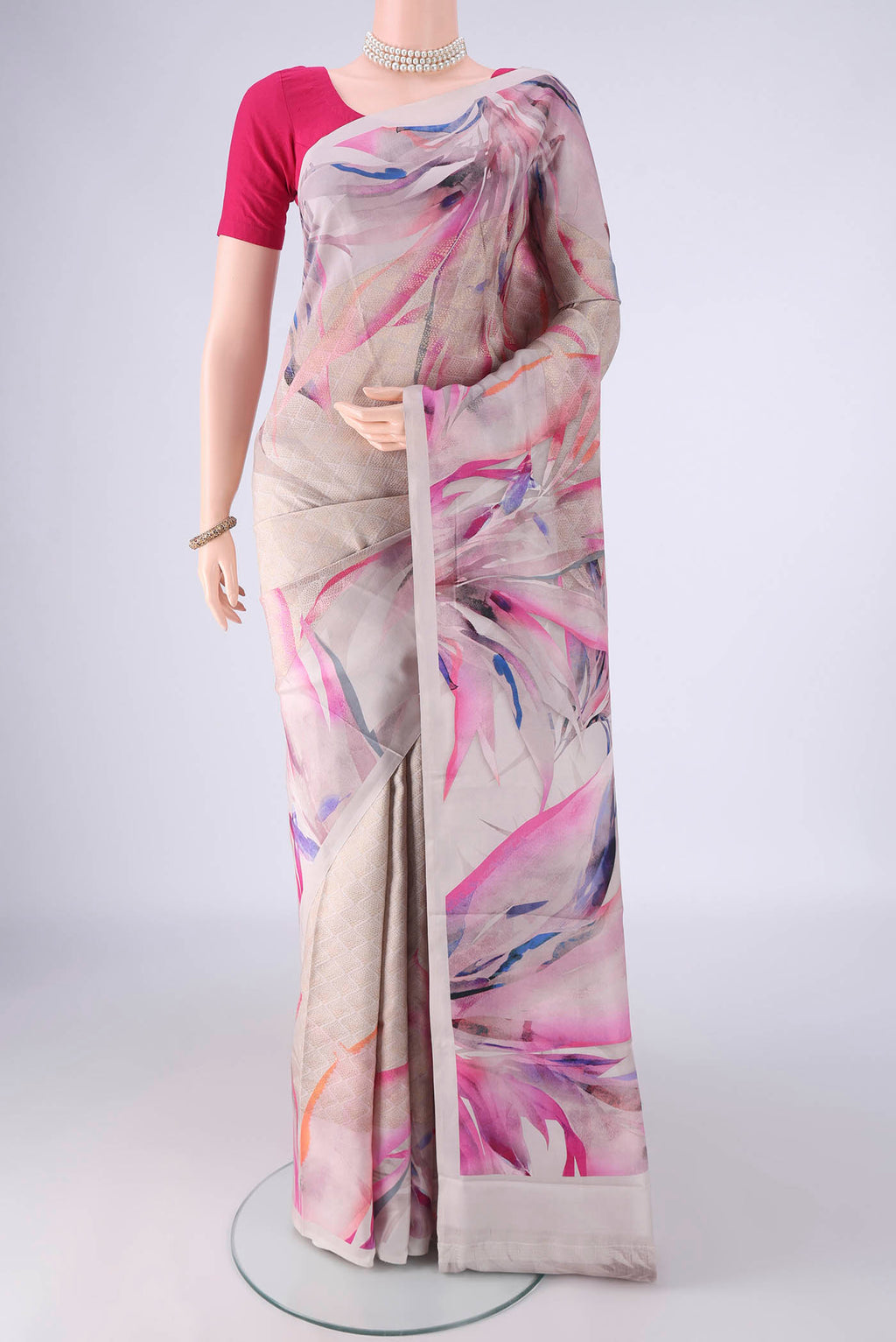 Grey Printed Silk Saree with Floral Print on the body and Zari Border.  displayed on a mannequin