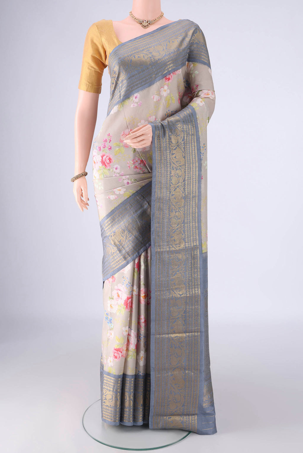 Dark Beige Kanchipuram Silk Saree with Floral Print on the body and Zari Border.  displayed on a mannequin