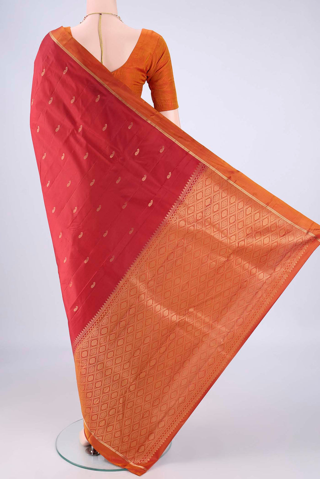 Flat view of Red Kanjivaram Silk Saree with Zari Butta on the body and Plain Border. 