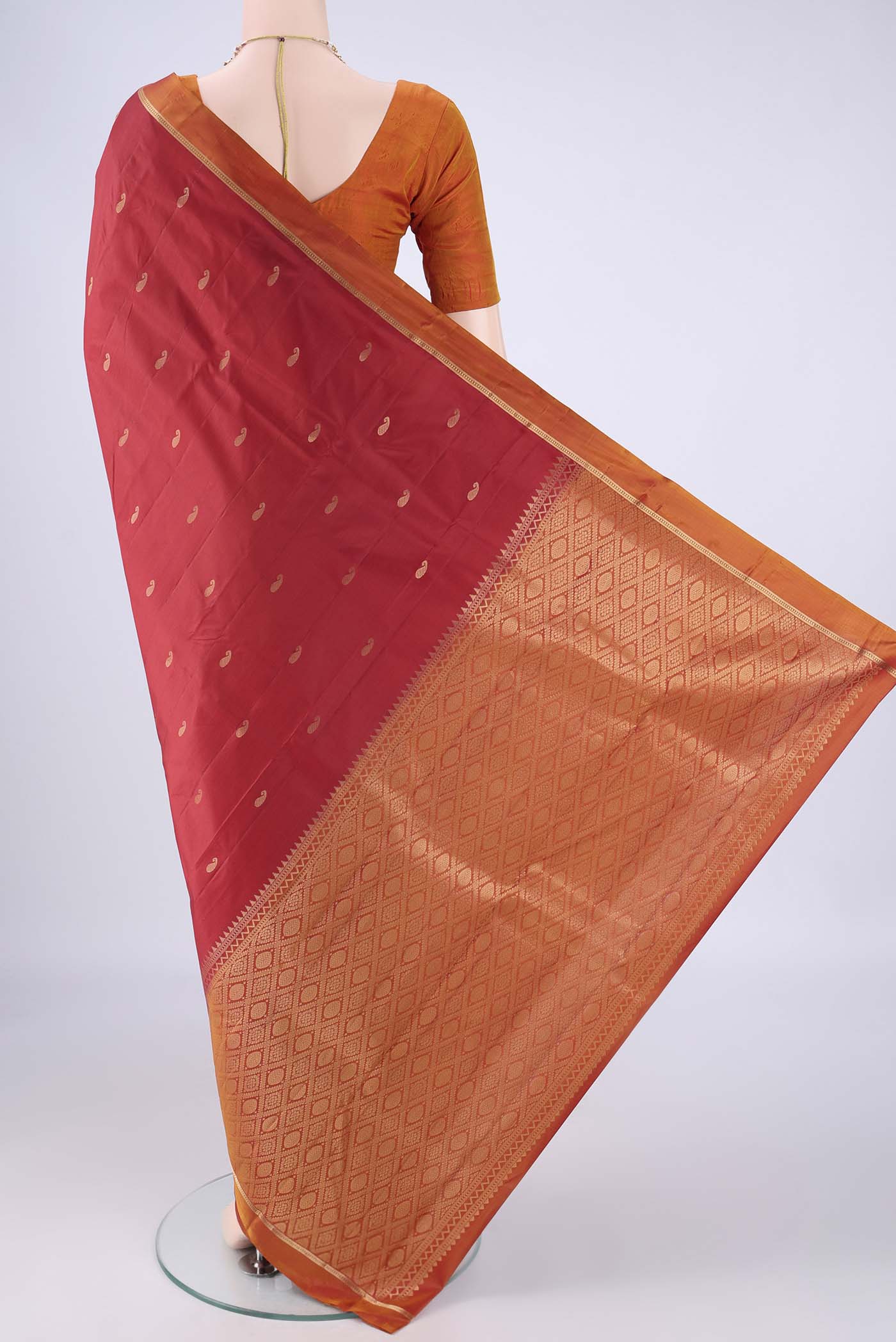 Flat view of Red Kanjivaram Silk Saree with Zari Butta on the body and Plain Border. 
