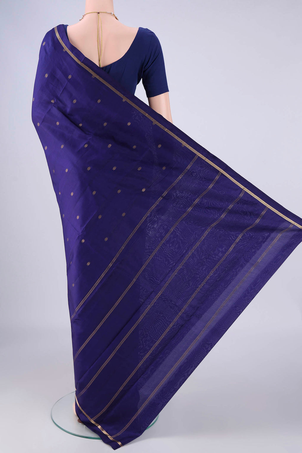 Flat view of Navy Blue Kanjivaram Silk Saree with Zari Butta on the body and Thin Zari Line. 