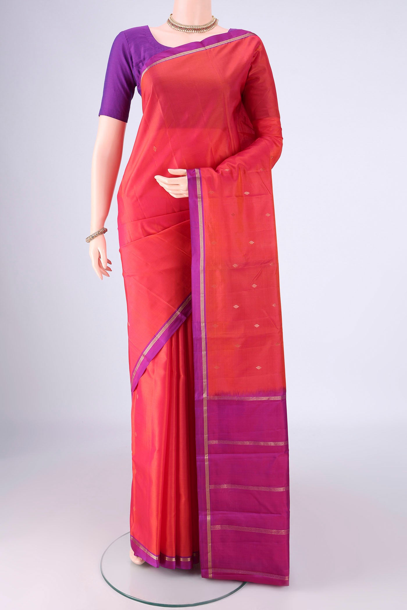 Dark Pink Kanjivaram Silk Saree with Zari Butta on the body and Zari Border.  displayed on a mannequin