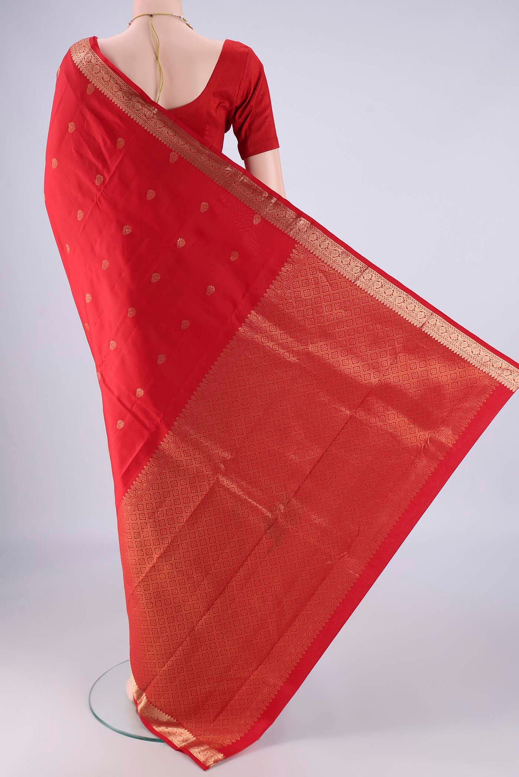 Flat view of Red Kanjivaram Silk Saree with Zari Butta on the body and Zari Border. 