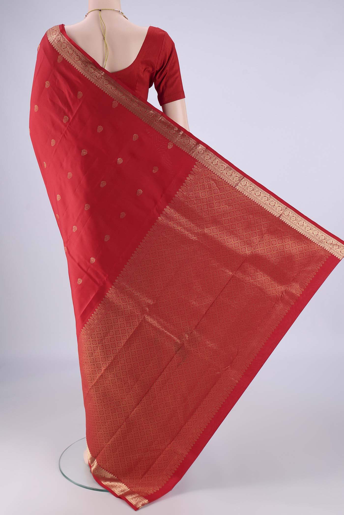 Flat view of Red Kanjivaram Silk Saree with Zari Butta on the body and Zari Border. 
