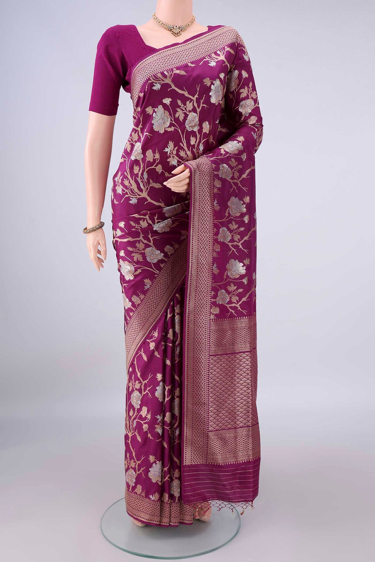 Pure Silk Magenta Banarasi Saree with Zari Butta on the body and Zari Border.  displayed on a mannequin