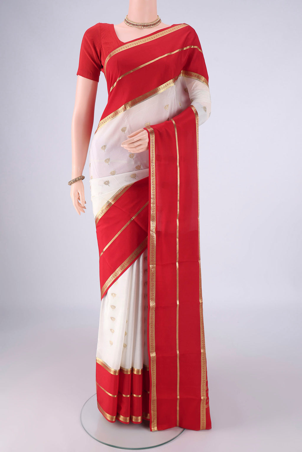 White Mysore Crepe Saree with Zari Butta on the body and Zari Border.  displayed on a mannequin