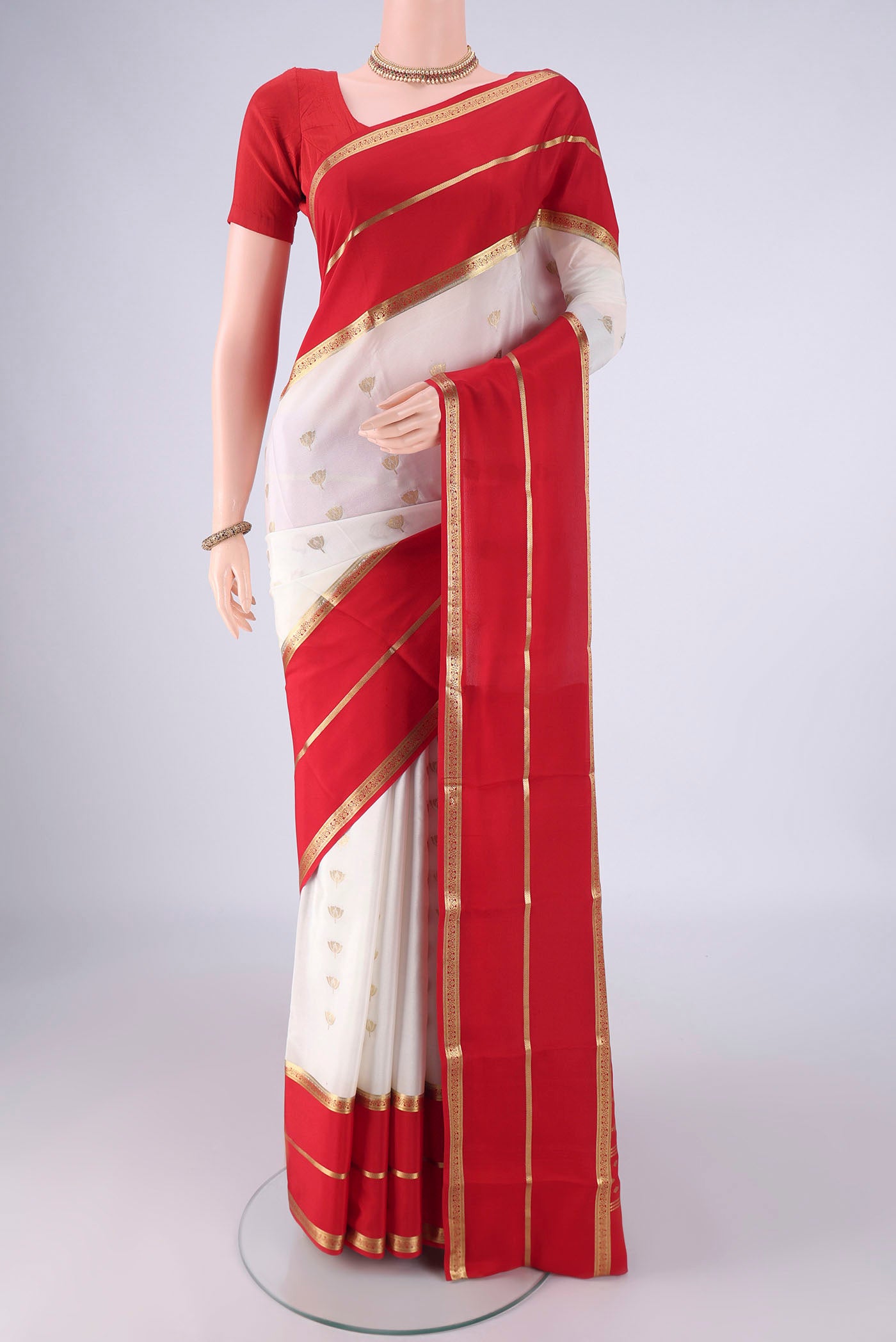 White Mysore Crepe Saree with Zari Butta on the body and Zari Border.  displayed on a mannequin