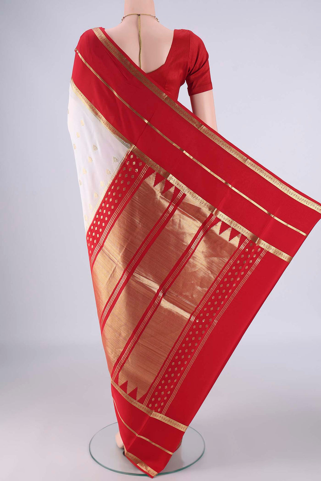 Flat view of White Mysore Crepe Saree with Zari Butta on the body and Zari Border. 