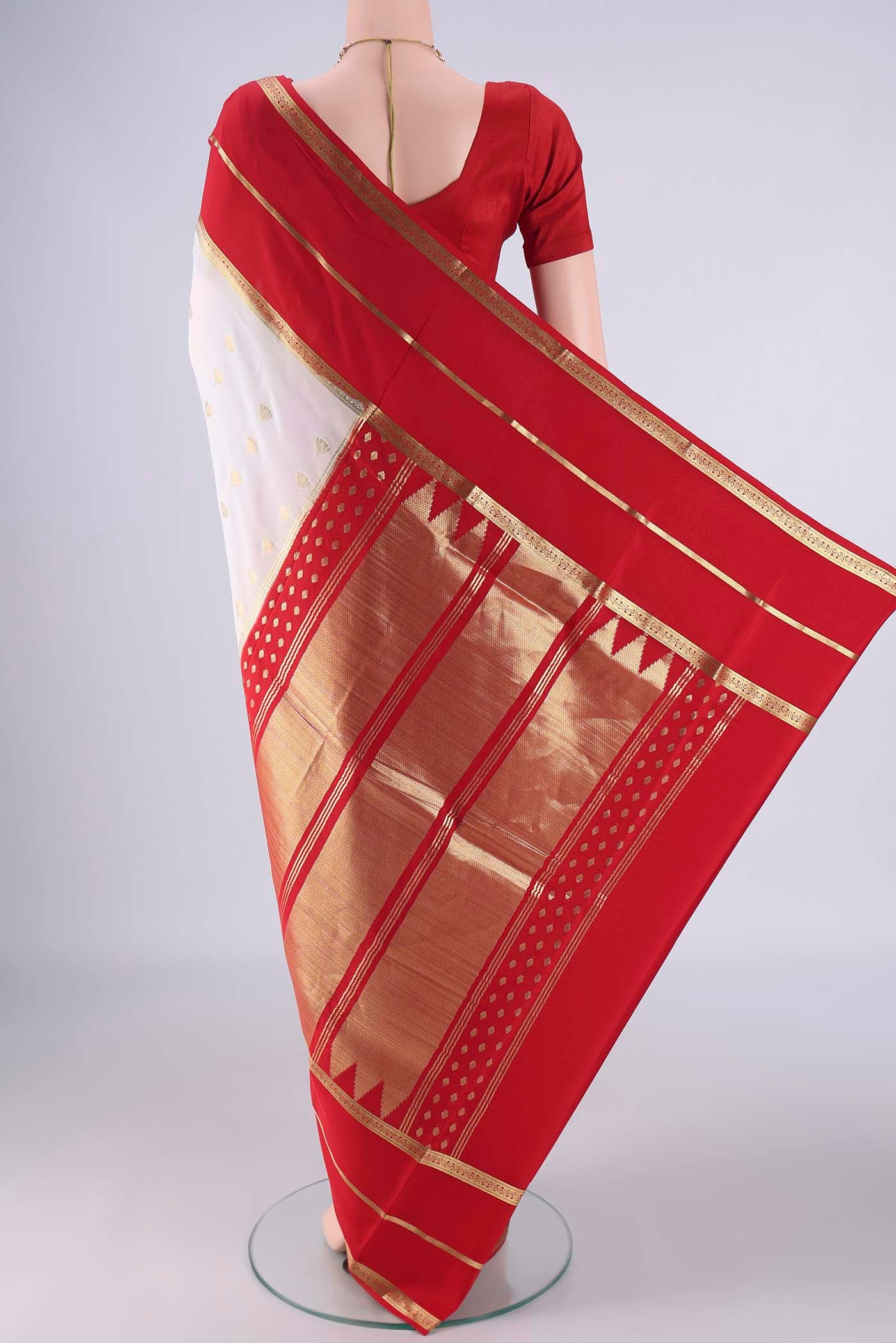 Flat view of White Mysore Crepe Saree with Zari Butta on the body and Zari Border. 