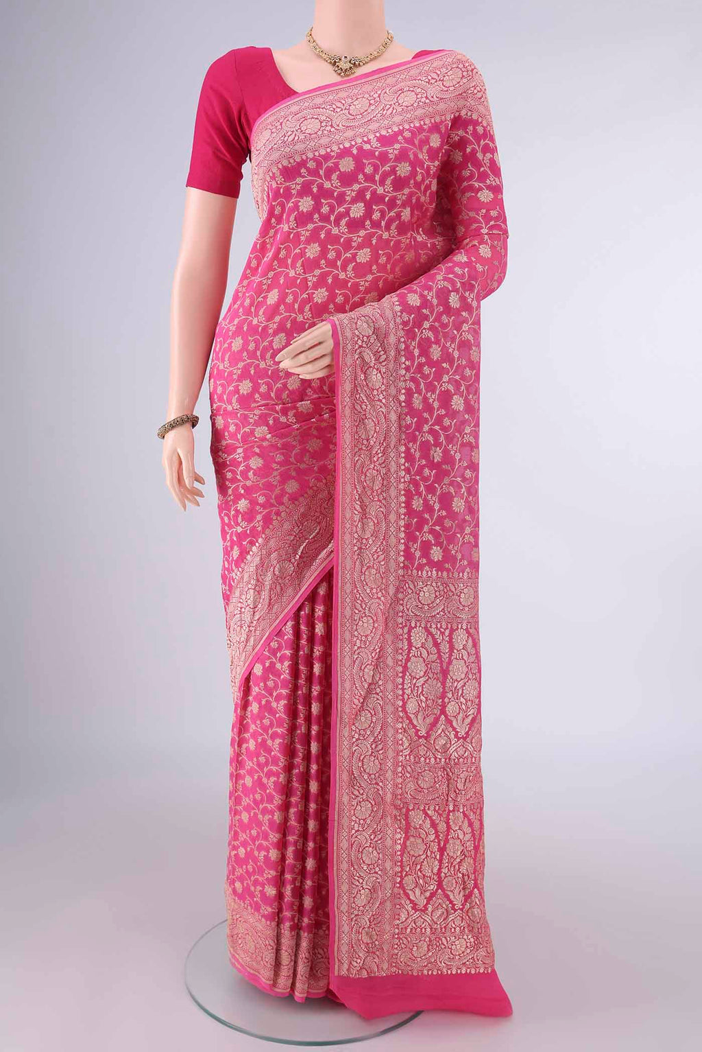 Pink Banarasi Georgette Saree with Zari Brocade on the body and Zari Border.  displayed on a mannequin