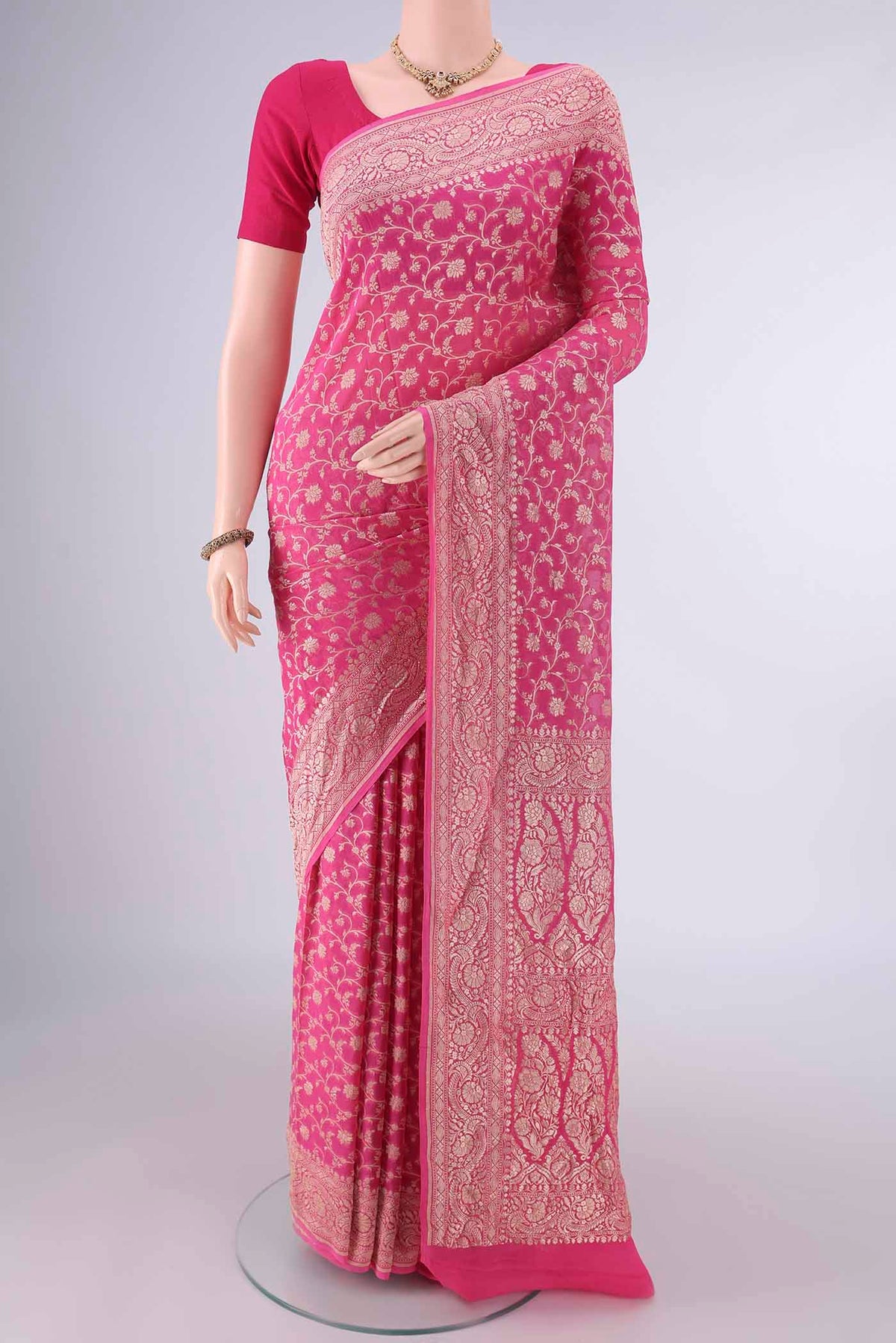 Pink Banarasi Georgette Saree with Zari Brocade on the body and Zari Border.  displayed on a mannequin