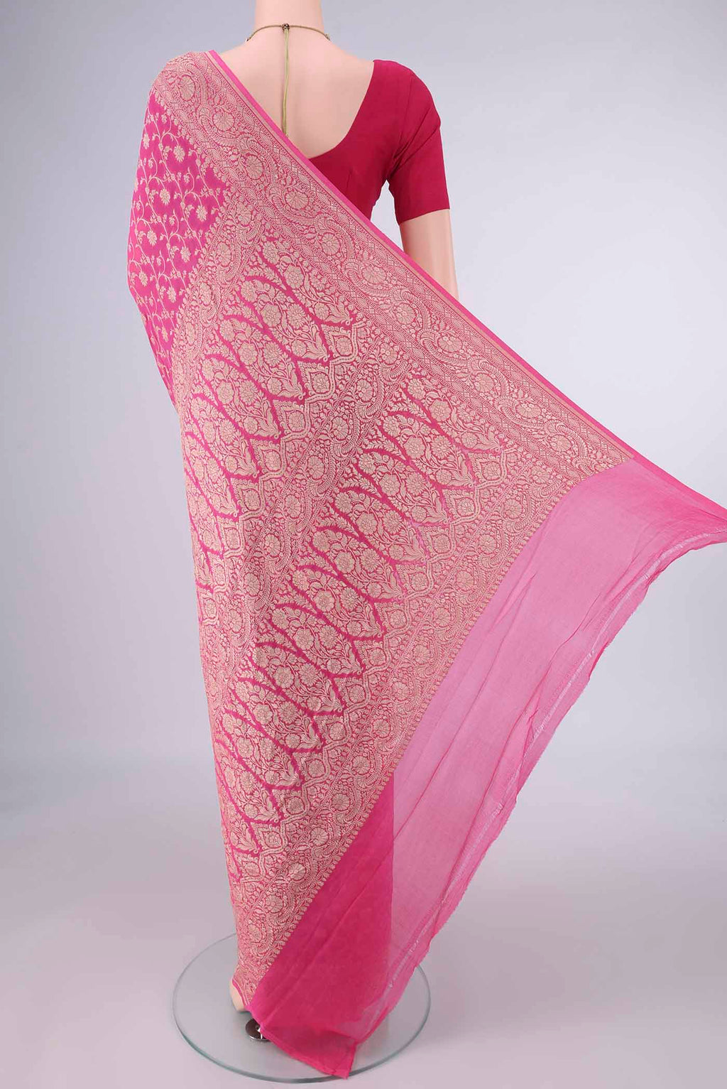Flat view of Pink Banarasi Georgette Saree with Zari Brocade on the body and Zari Border. 