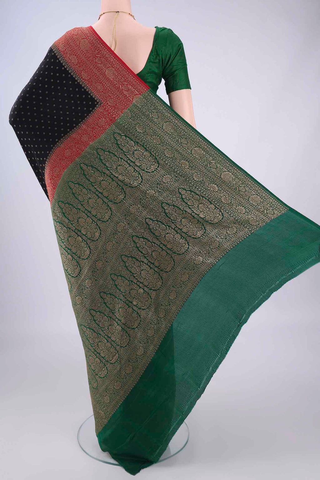 Flat view of Black Banarasi Georgette Saree with Zari Butta on the body and Zari Border. 