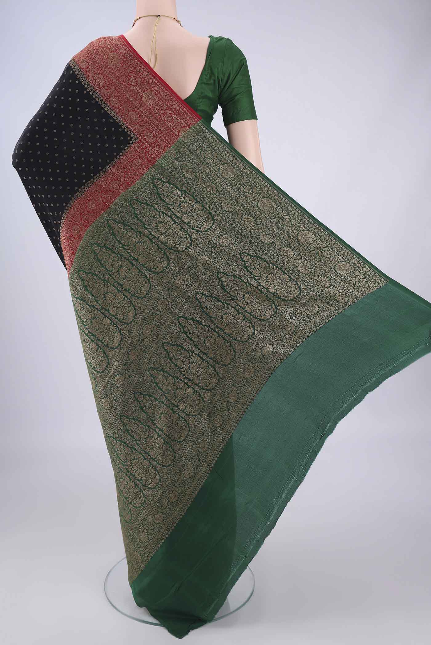 Flat view of Black Banarasi Georgette Saree with Zari Butta on the body and Zari Border. 