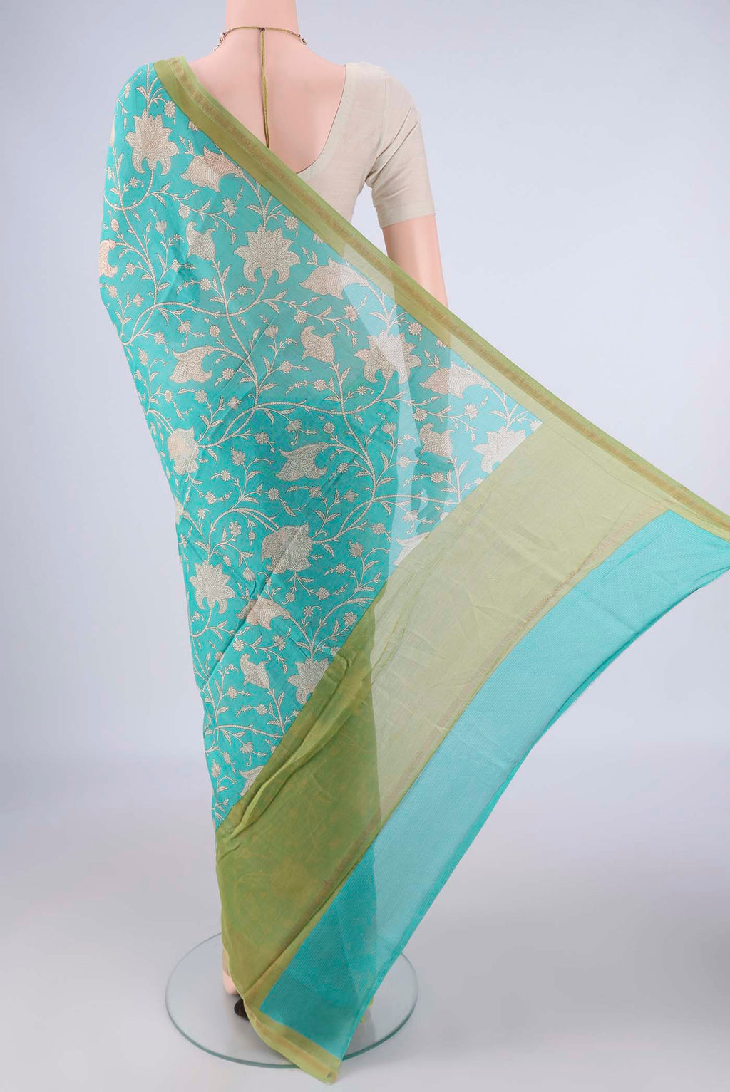 Flat view of Turquoise Chanderi Silk Cotton Saree with Printed design on the body and Thin Zari Line. 