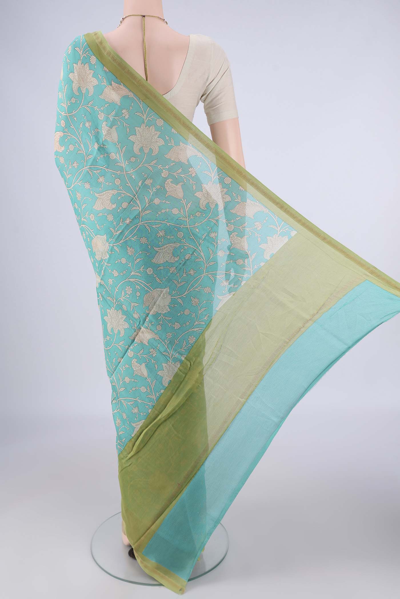 Flat view of Turquoise Chanderi Silk Cotton Saree with Printed design on the body and Thin Zari Line. 