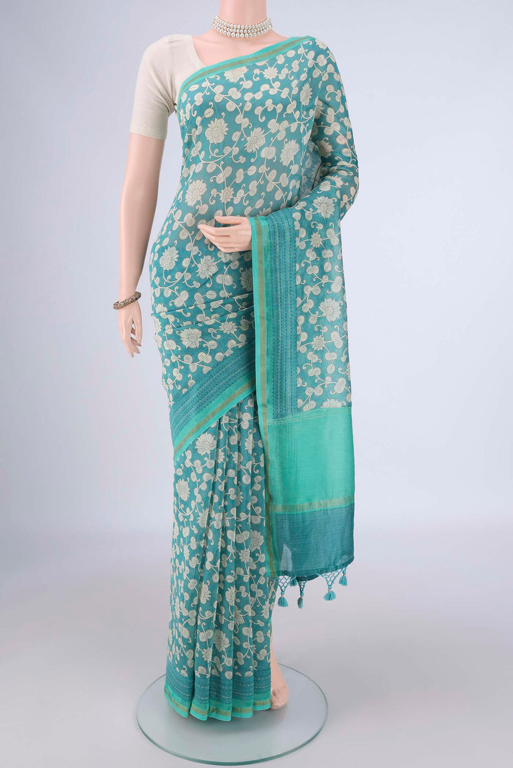Blue Chanderi Silk Cotton Saree with Printed design on the body and Thread Border.  displayed on a mannequin